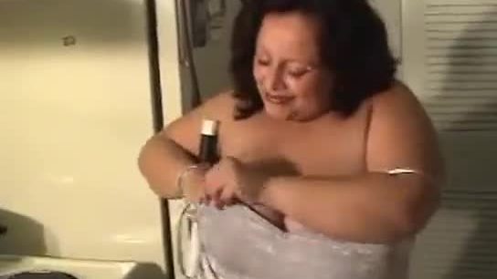 Busty fat woman cleans the house