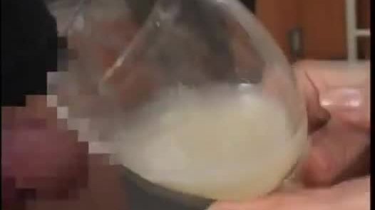 Playful asian drinks cum from a glass